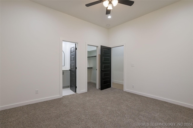 unfurnished bedroom with ensuite bath, ceiling fan, and light carpet