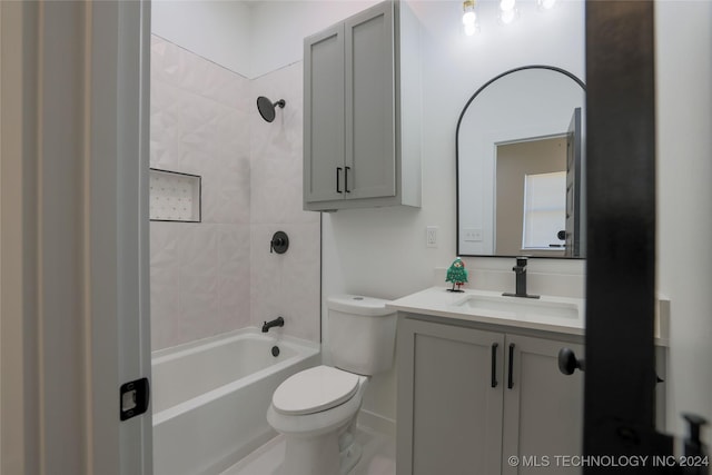 full bathroom featuring vanity, toilet, and tiled shower / bath