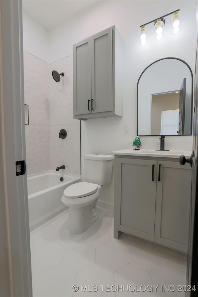 full bathroom with tile patterned floors, vanity, toilet, and tiled shower / bath