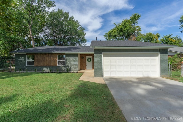 single story home featuring a garage and a front yard