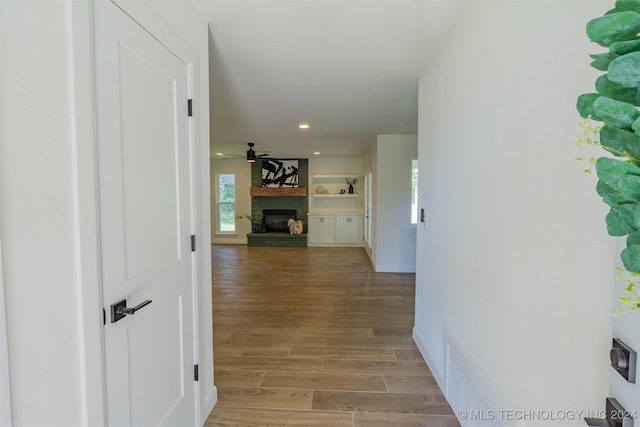 corridor with light hardwood / wood-style floors