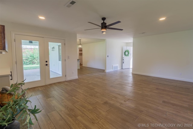 interior space with hardwood / wood-style floors, ceiling fan, and french doors