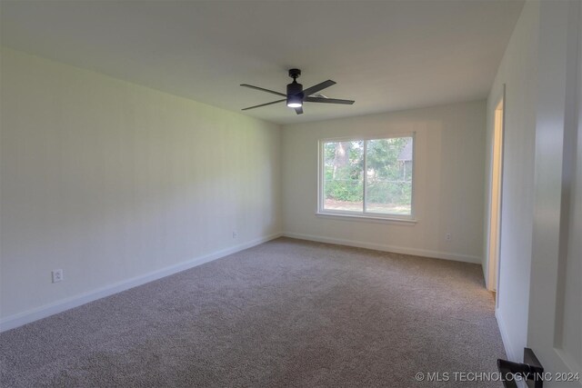 unfurnished room with ceiling fan and carpet floors