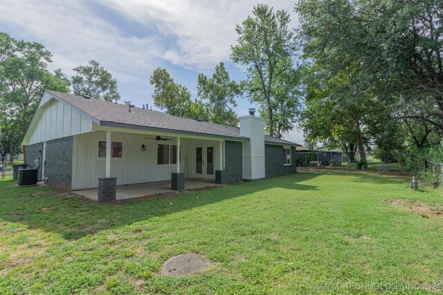 rear view of house with central air condition unit, a yard, and a patio