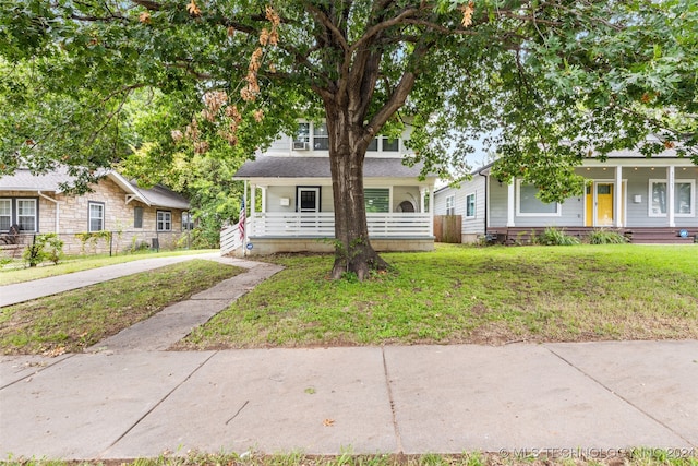 view of front of home featuring a front yard and a porch