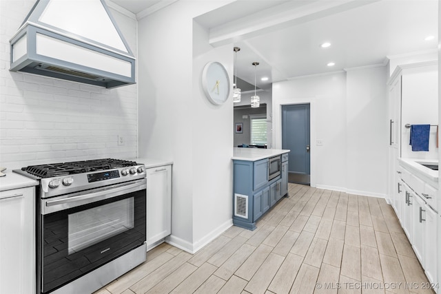 kitchen with stainless steel appliances, white cabinetry, and light hardwood / wood-style floors