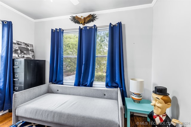 bedroom with crown molding, multiple windows, and hardwood / wood-style flooring