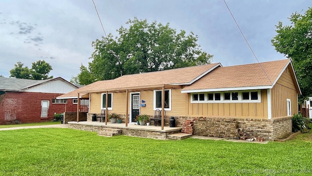 rear view of house featuring a patio and a lawn