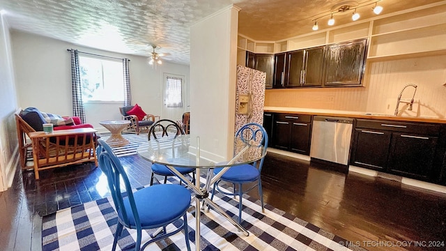 dining area featuring a textured ceiling, ceiling fan, sink, and dark hardwood / wood-style flooring