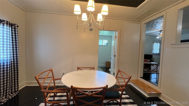 dining room with crown molding, hardwood / wood-style flooring, and ceiling fan with notable chandelier