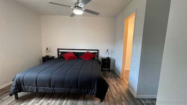 bedroom with ceiling fan and hardwood / wood-style flooring