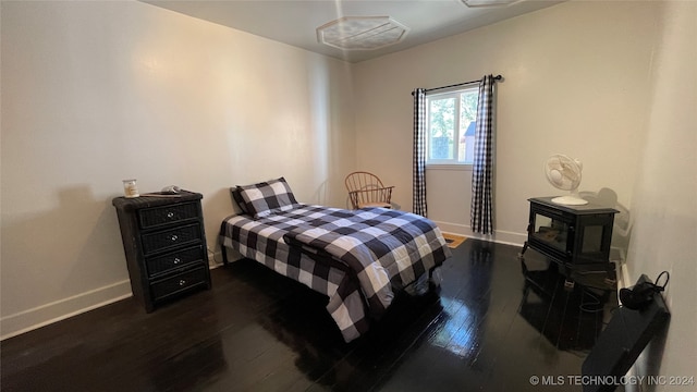 bedroom with dark hardwood / wood-style floors