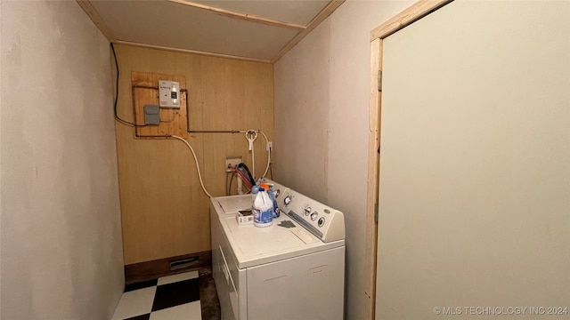 laundry area with washer / dryer and wooden walls