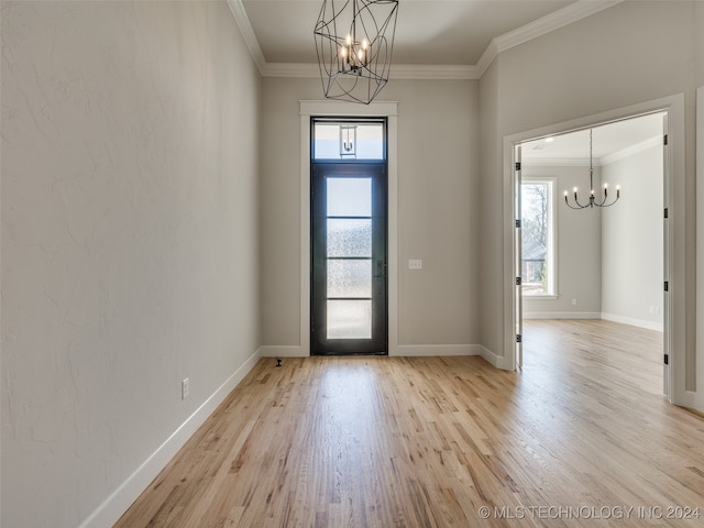 foyer featuring crown molding, a healthy amount of sunlight, and light hardwood / wood-style floors