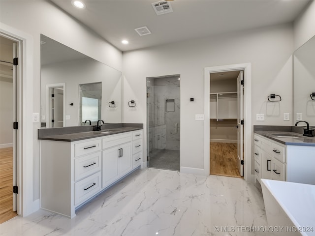 bathroom with hardwood / wood-style floors, vanity, and shower with separate bathtub