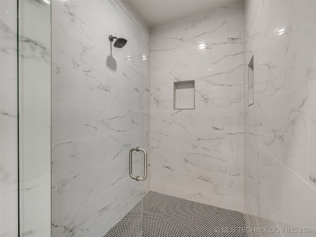 bathroom featuring a shower with shower door