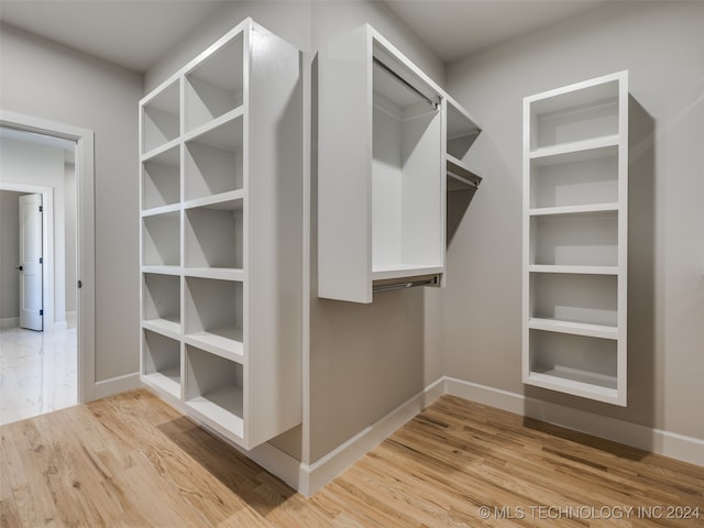 spacious closet with light hardwood / wood-style floors