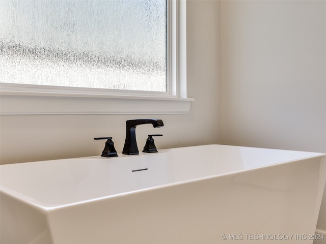 interior details with a tub to relax in and sink