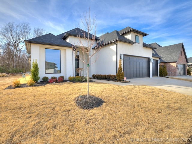 view of front facade with a garage and a front lawn