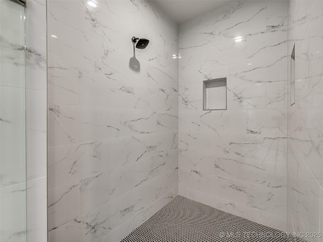 bathroom featuring a tile shower