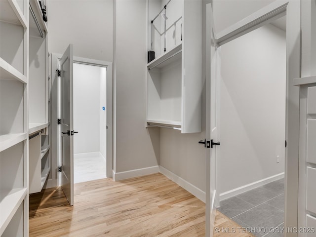 spacious closet featuring light hardwood / wood-style flooring