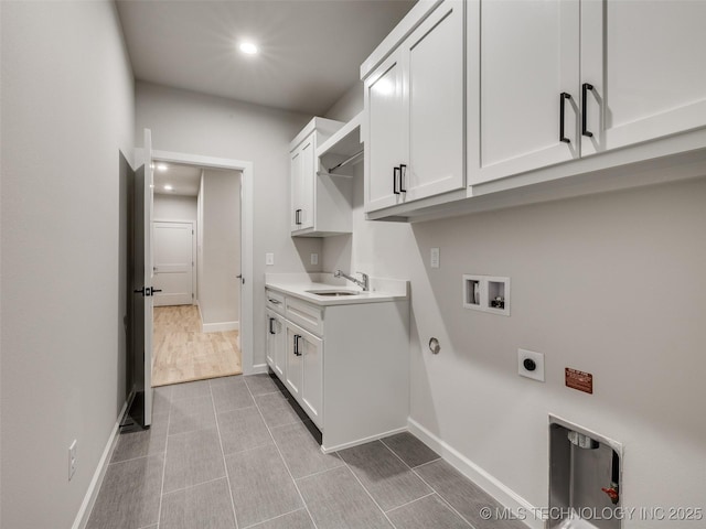 washroom with gas dryer hookup, sink, hookup for a washing machine, cabinets, and hookup for an electric dryer