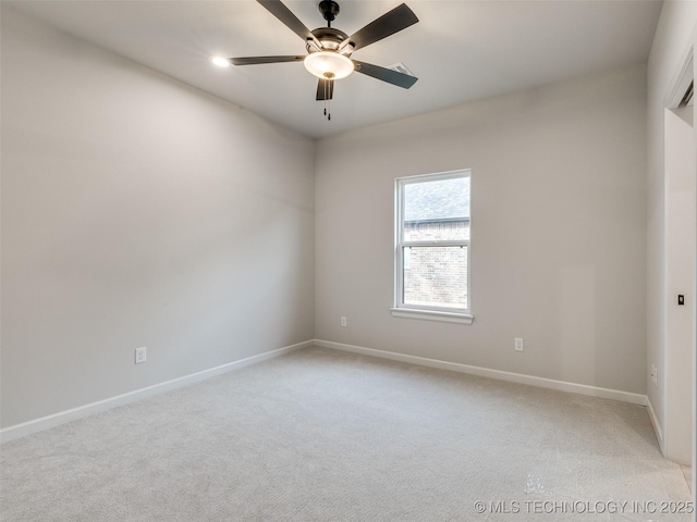 carpeted spare room with ceiling fan