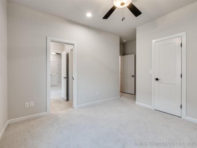 unfurnished bedroom featuring light carpet and ceiling fan