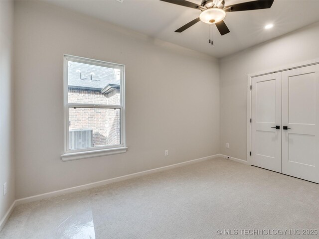 unfurnished bedroom with light carpet, a closet, and ceiling fan