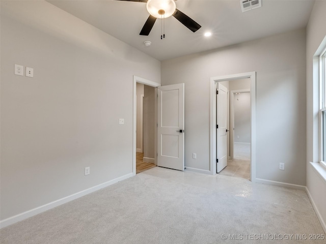 unfurnished bedroom featuring ceiling fan and light carpet