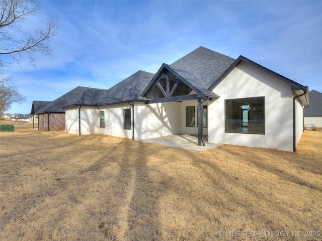 back of property with a patio and a lawn