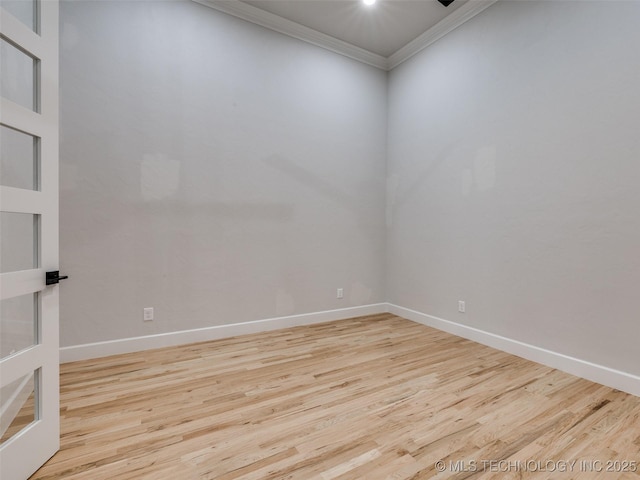 spare room featuring crown molding and light hardwood / wood-style floors