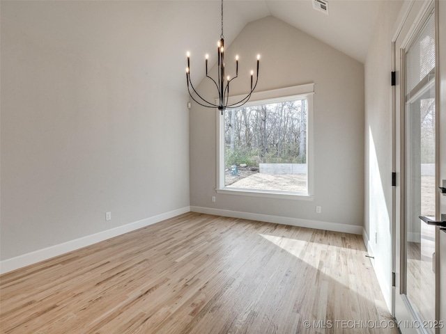 unfurnished dining area with high vaulted ceiling, light hardwood / wood-style floors, and a chandelier