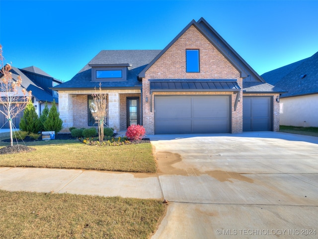 view of front of house featuring a garage and a front yard