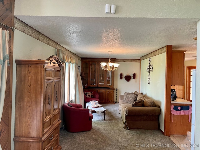 living room with a textured ceiling, an inviting chandelier, and light colored carpet