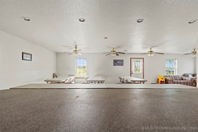 interior space featuring a textured ceiling and ceiling fan