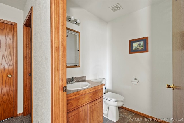 bathroom with tile patterned flooring, toilet, and vanity