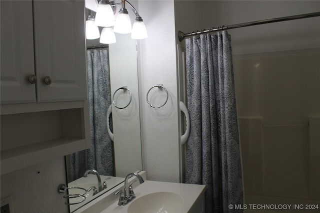 bathroom featuring a shower with curtain and a sink