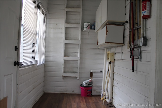 interior space with wood finished floors and wooden walls