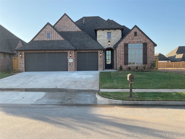 view of front of property featuring a front yard and a garage