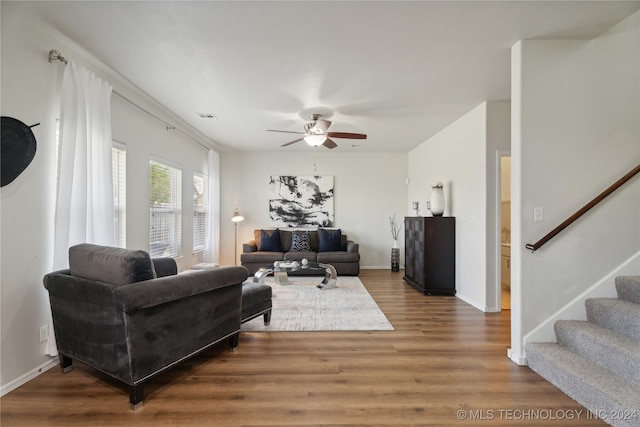 living room with ceiling fan and dark hardwood / wood-style floors