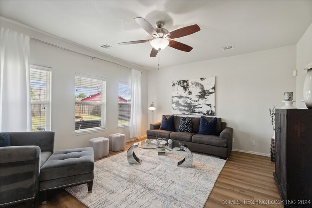 living room featuring wood-type flooring and ceiling fan