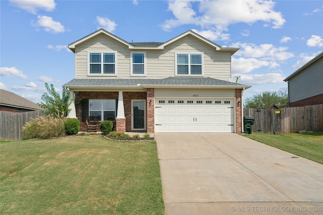 view of front of house with a garage and a front yard