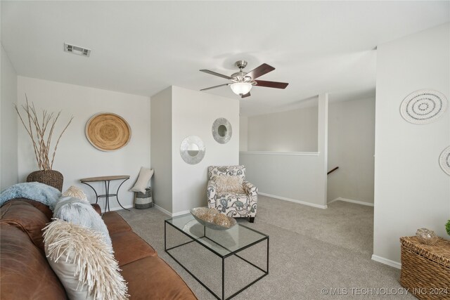 carpeted living room featuring ceiling fan