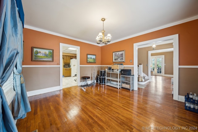 office area with a notable chandelier, hardwood / wood-style flooring, french doors, and crown molding