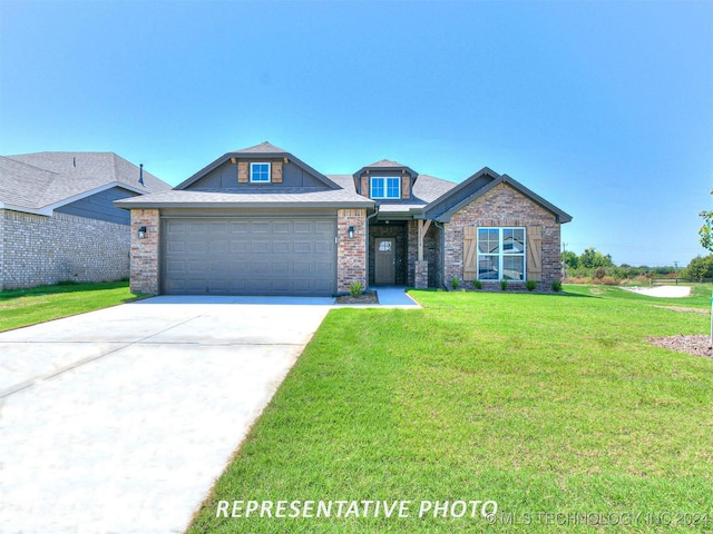 view of front of house featuring a front lawn and a garage