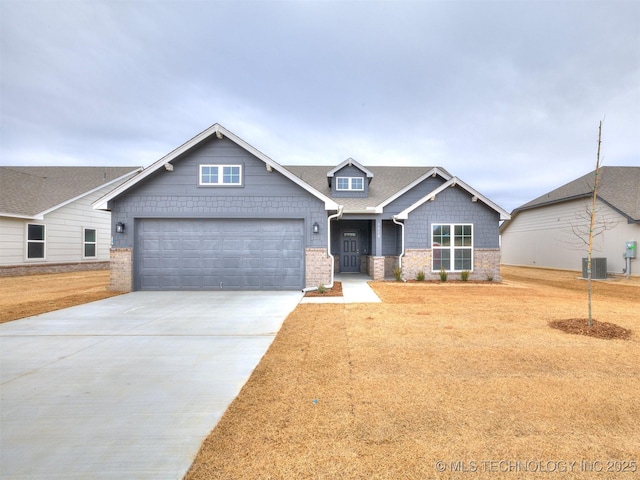 craftsman-style home featuring a garage and central air condition unit