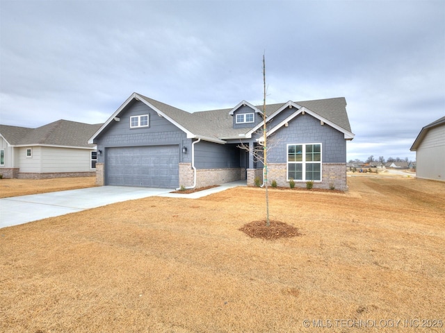 craftsman inspired home featuring a garage and a front lawn