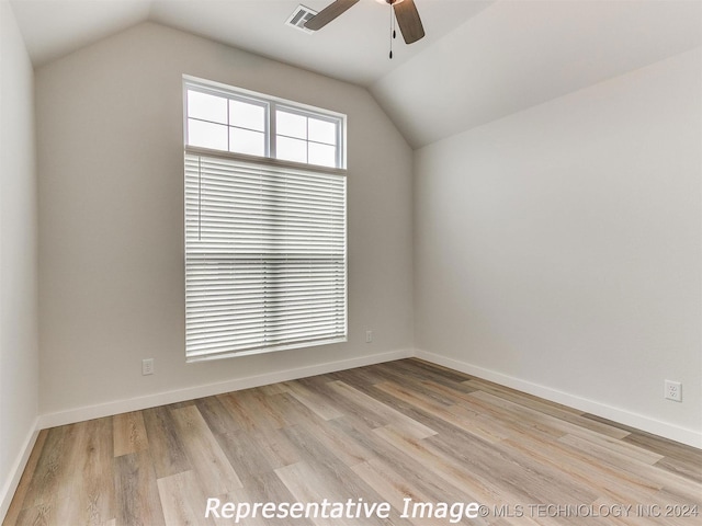 unfurnished room featuring lofted ceiling, light hardwood / wood-style flooring, and ceiling fan