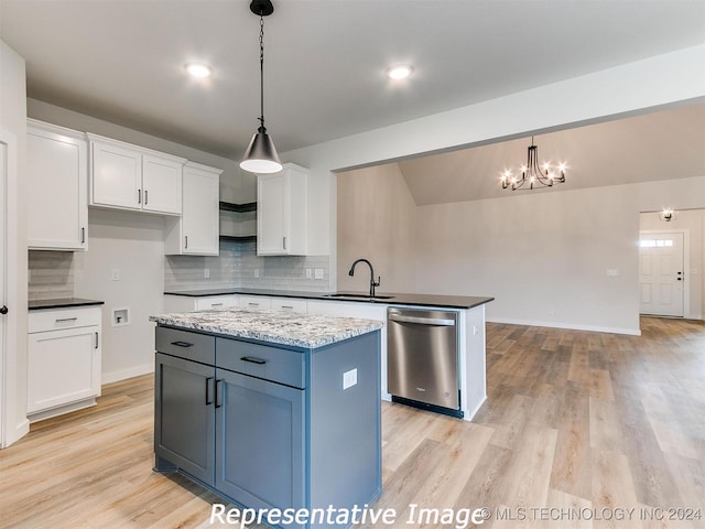 kitchen featuring hanging light fixtures, a kitchen island, white cabinetry, and stainless steel dishwasher